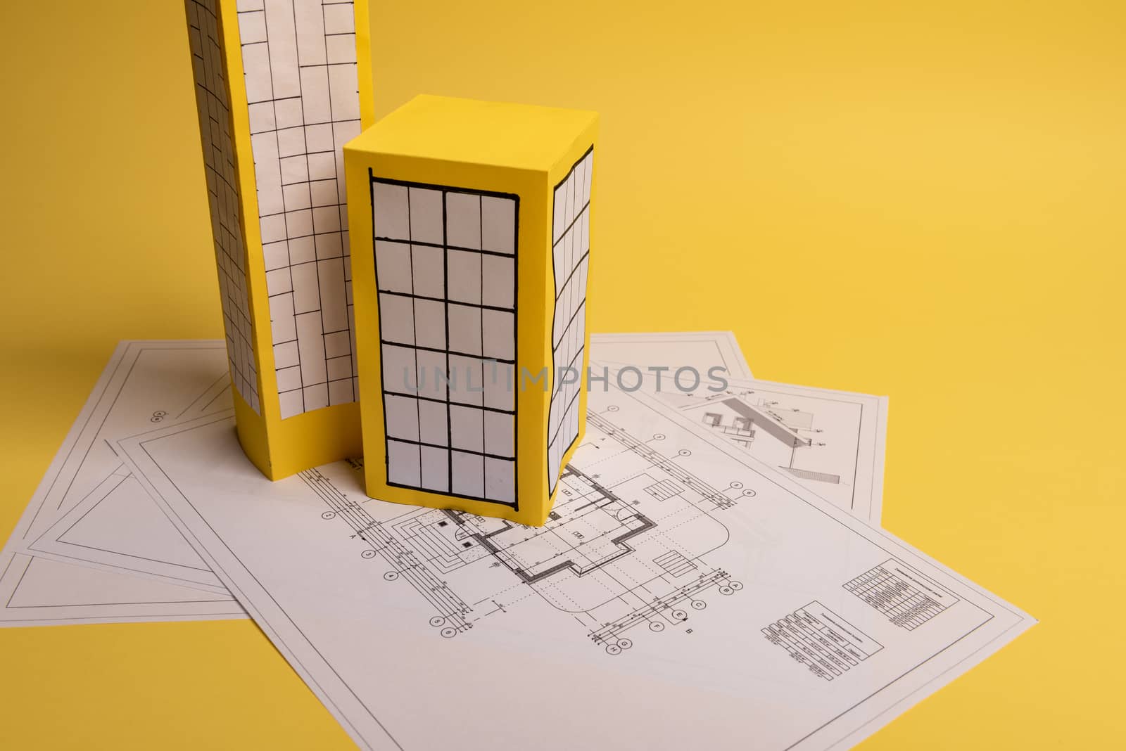 Yellow paper block of flats on yellow background paper. Minimalistic and simple concept, style. Copy space. Horizontal orientation.