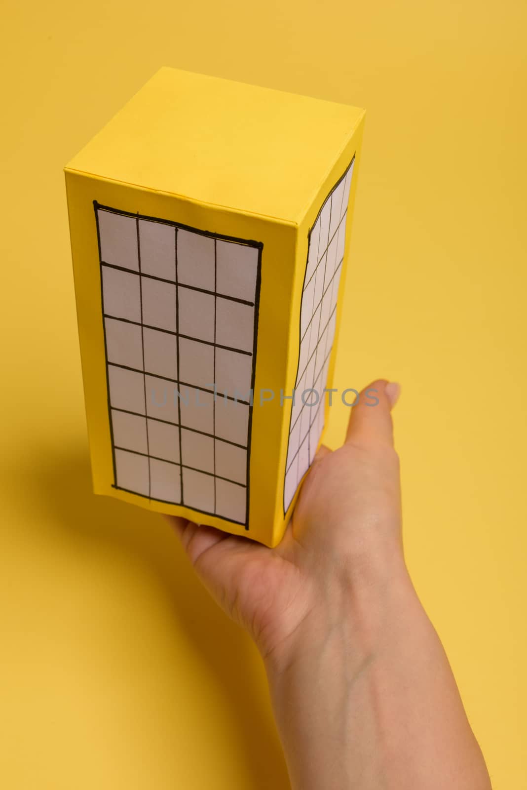 Yellow paper block of flats on yellow background paper. Minimalistic and simple concept, style. Copy space. Horizontal orientation.