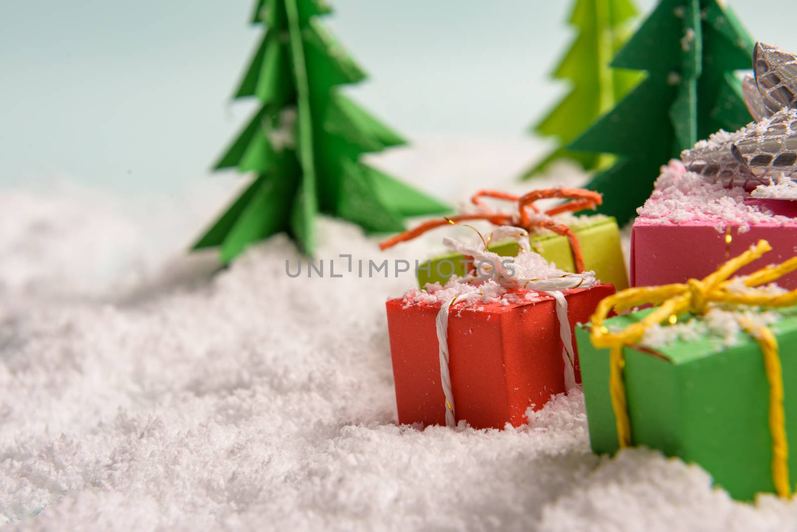 christmas presents nicely decorated with bows and feathers. view from above