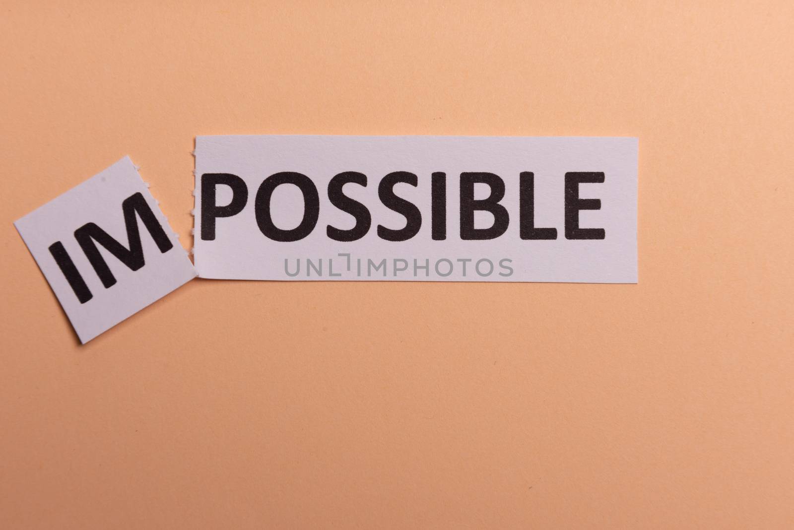 Impossible text cut out. Possible concept. Success. Pink background. Copy space. Vertical orientation. View from above. Minimal simple style