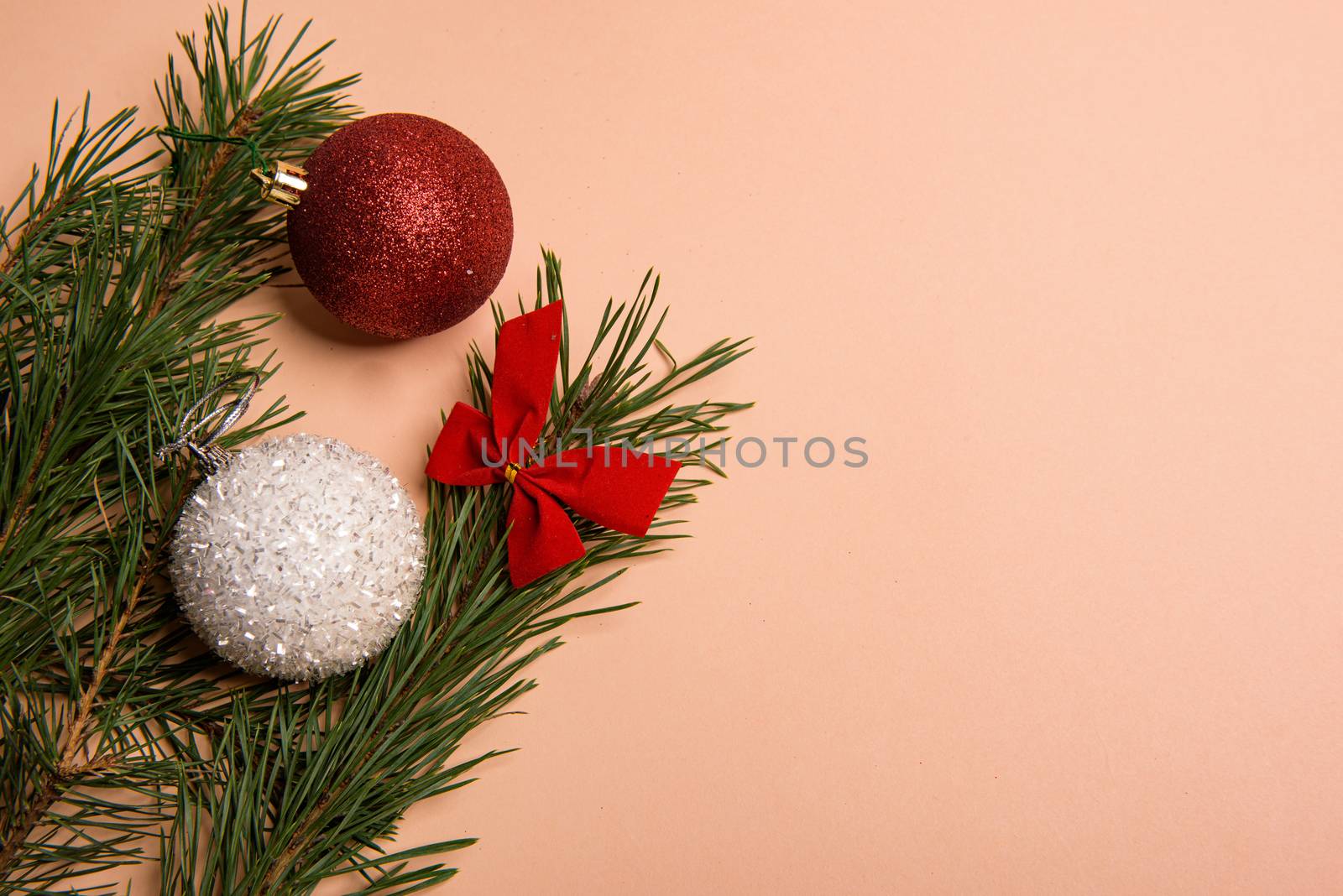 Christmas or New Year background, plain composition made of Xmas decorations and fir branches, flat lay, blank space for a greeting text.