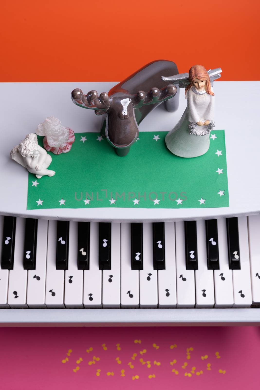 white toy piano with paper notes. music piano concept. view from above. White, black and yellow music notes.