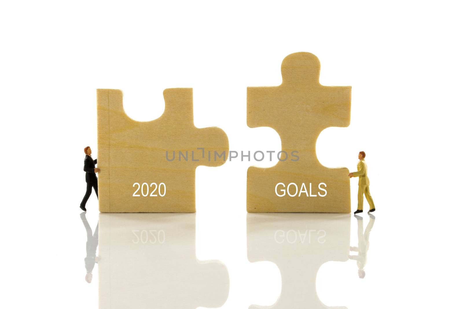 miniature people solving the puzzle problem how to set the goals for 2020