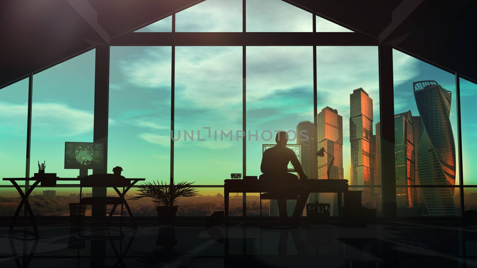 Male web designer working in office with panoramic window overlooking skyscrapers.
