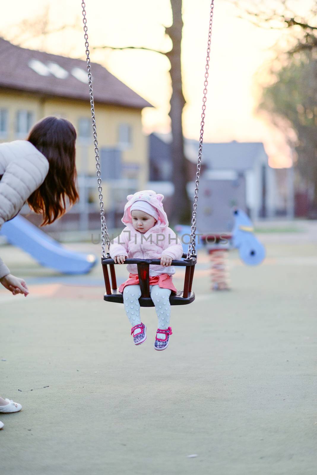 Little girl spending fantastic time on playground. Happy childhood.