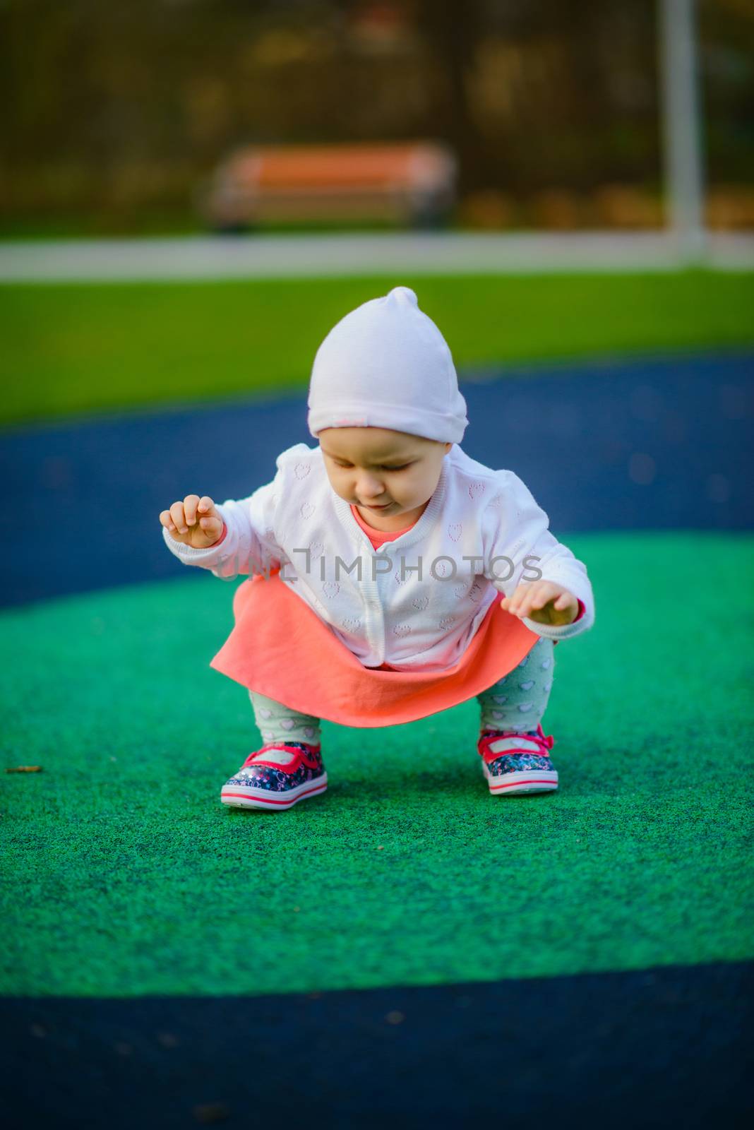 Little girl spending fantastic time on playground. Happy childhood.
