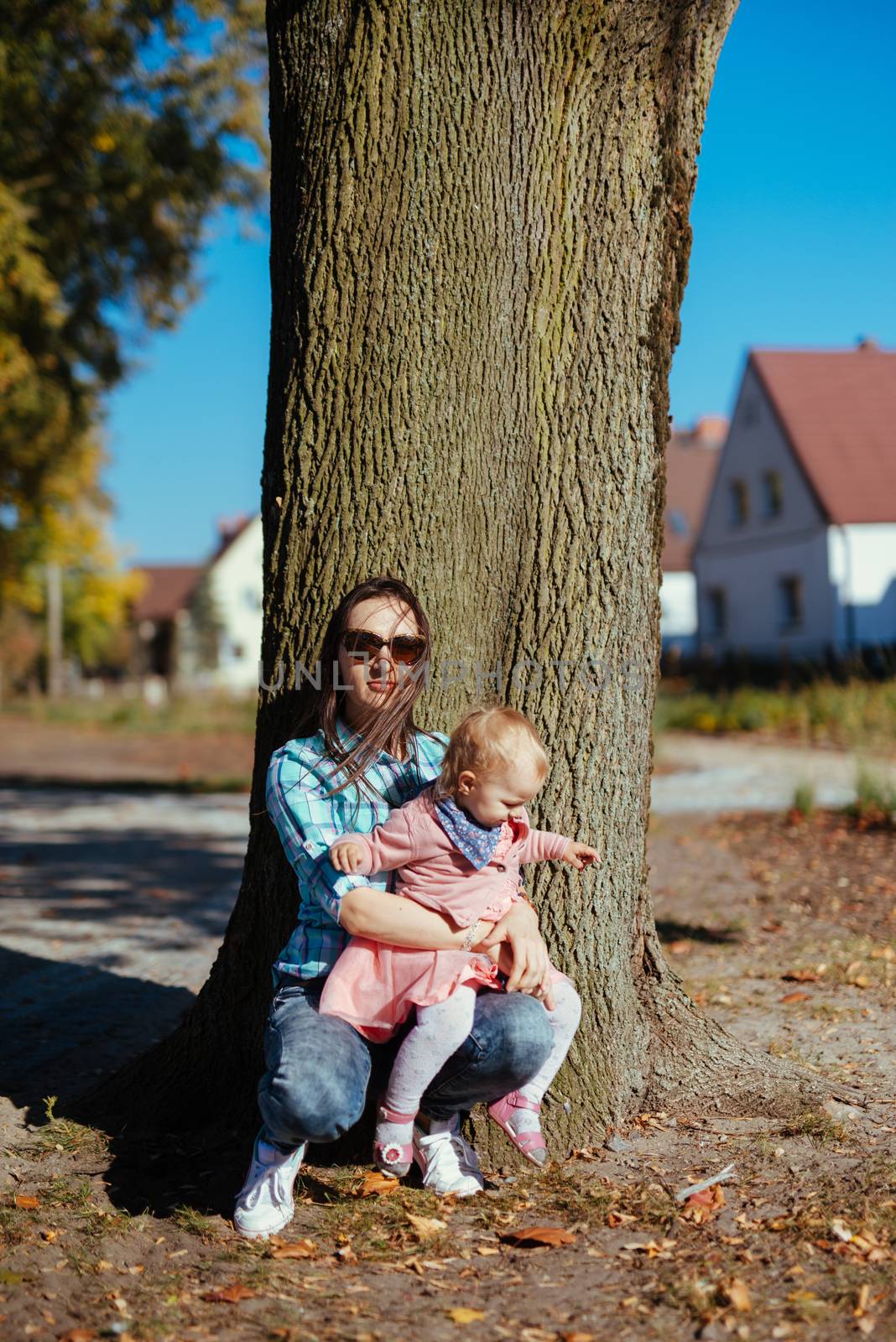 happy family mother and child little daughter running and playing on autumn walk