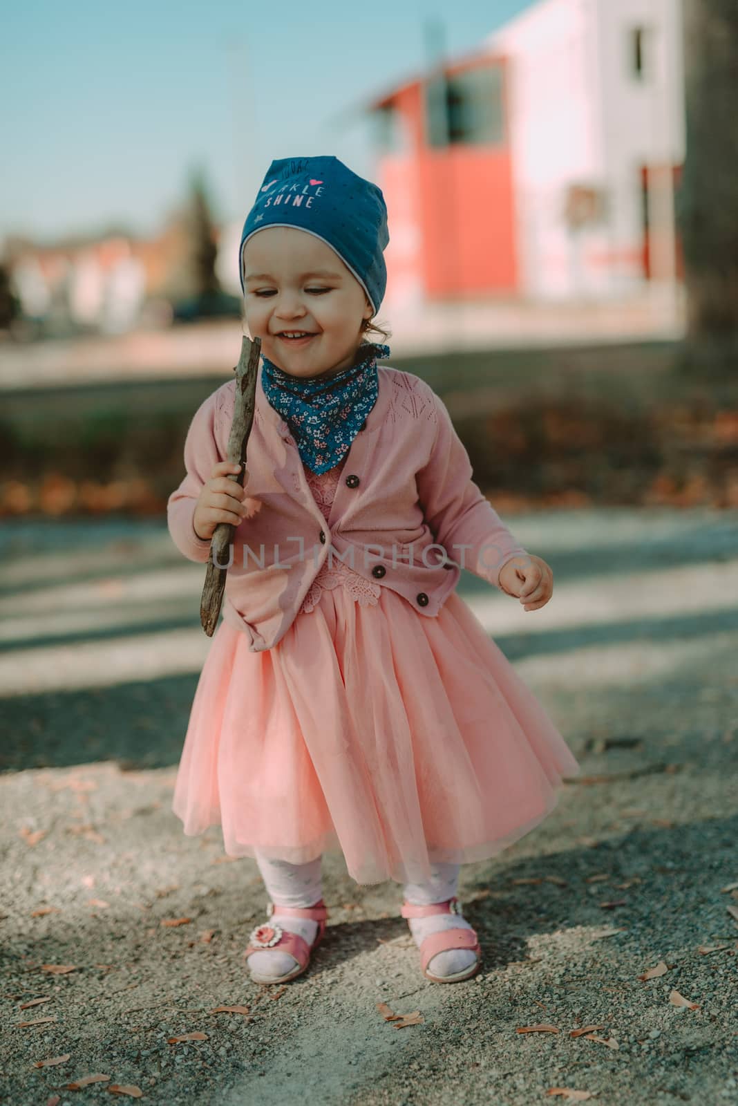 Adorable girl having fun on beautiful autumn day.