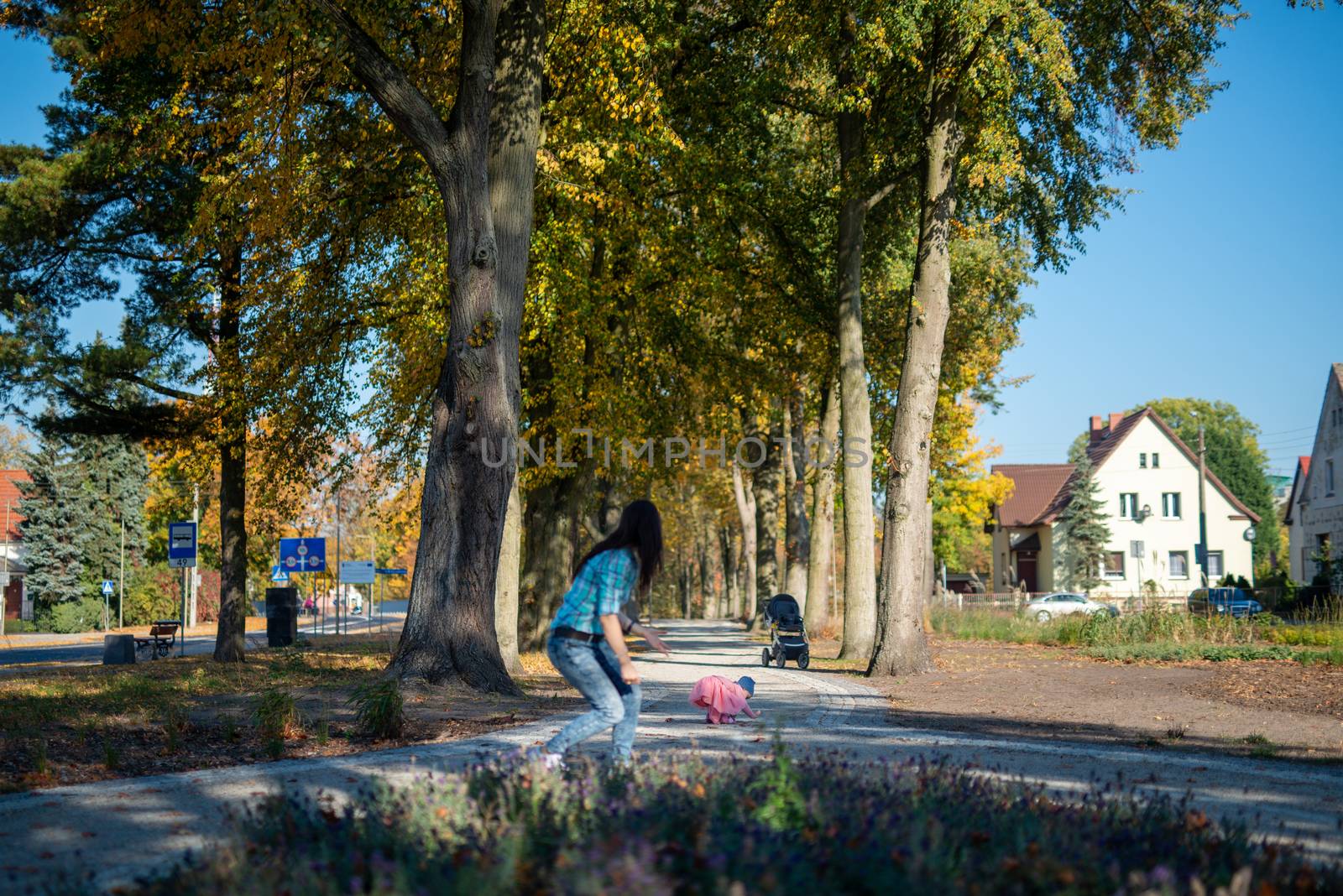 happy family mother and child little daughter running and playing on autumn walk