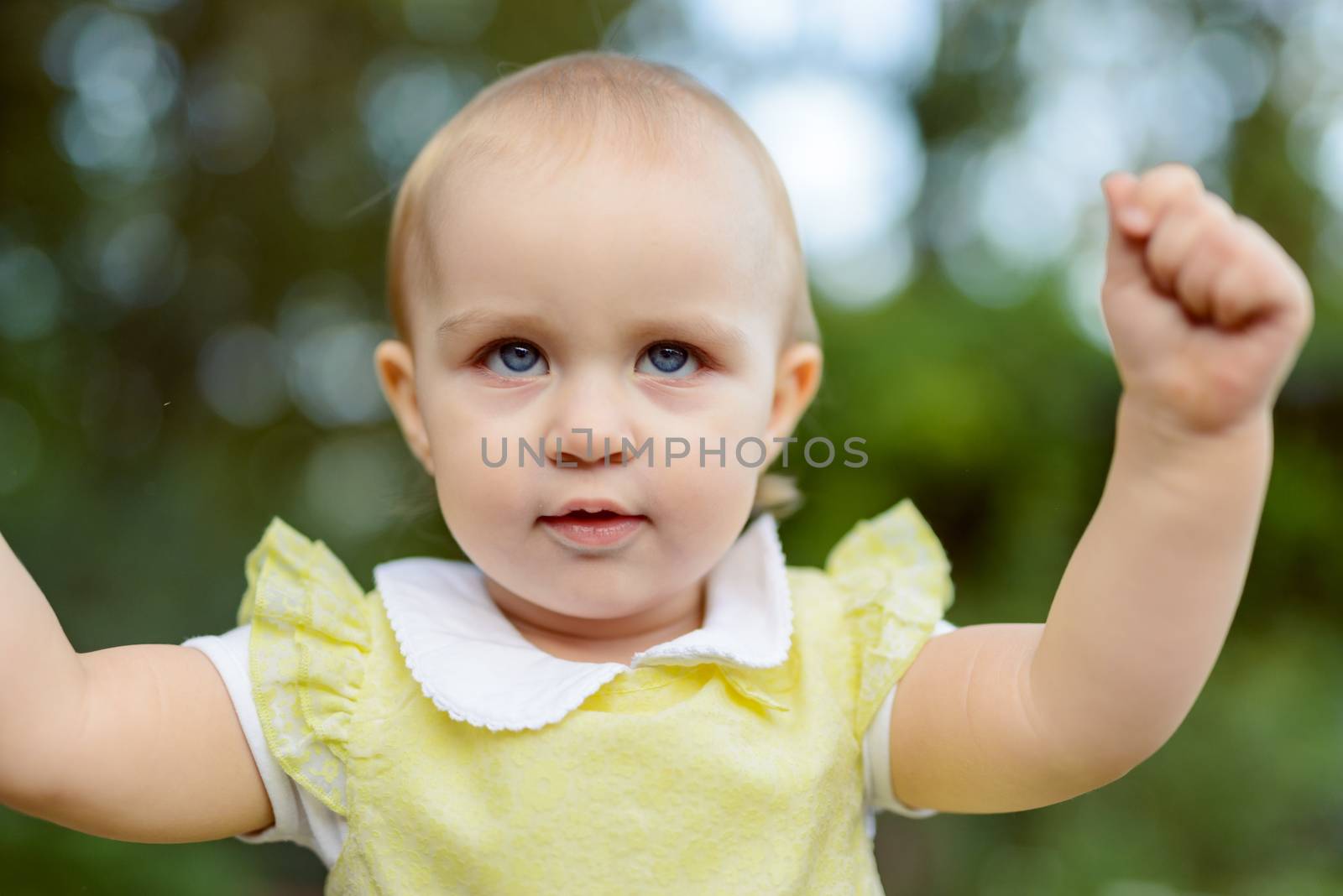 Smiling girl in the park in summer time. Authentic lifestyle image