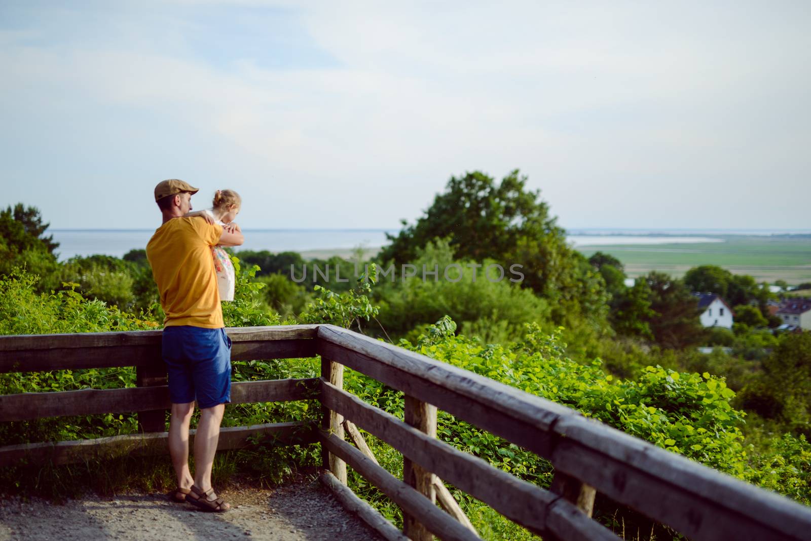 Happy loving family. Father and his daughter child girl playing and hugging outdoors. Cute little girl hugs daddy. Concept of Father's day.