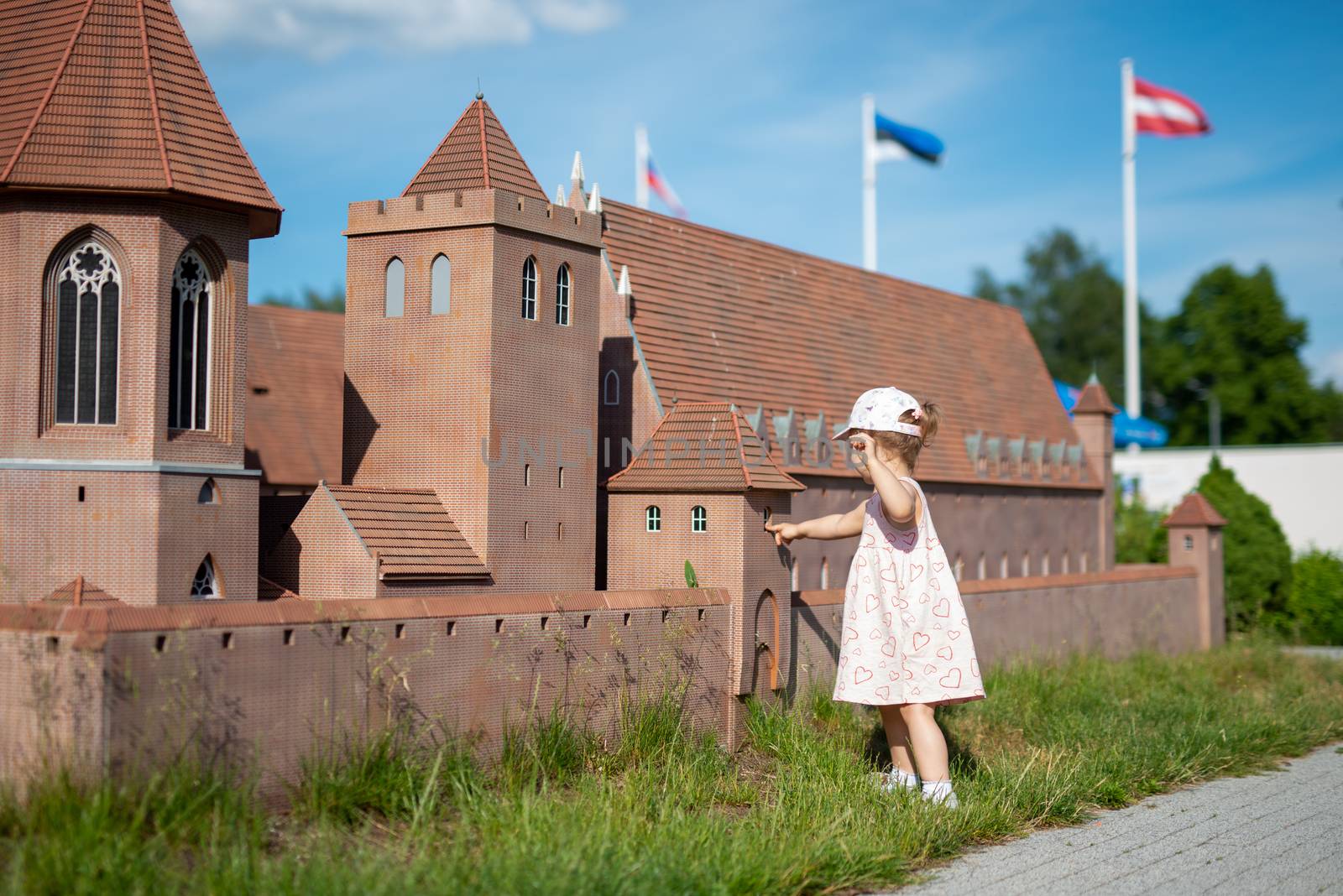 Little girl spending fantastic time on playground. Happy childhood.