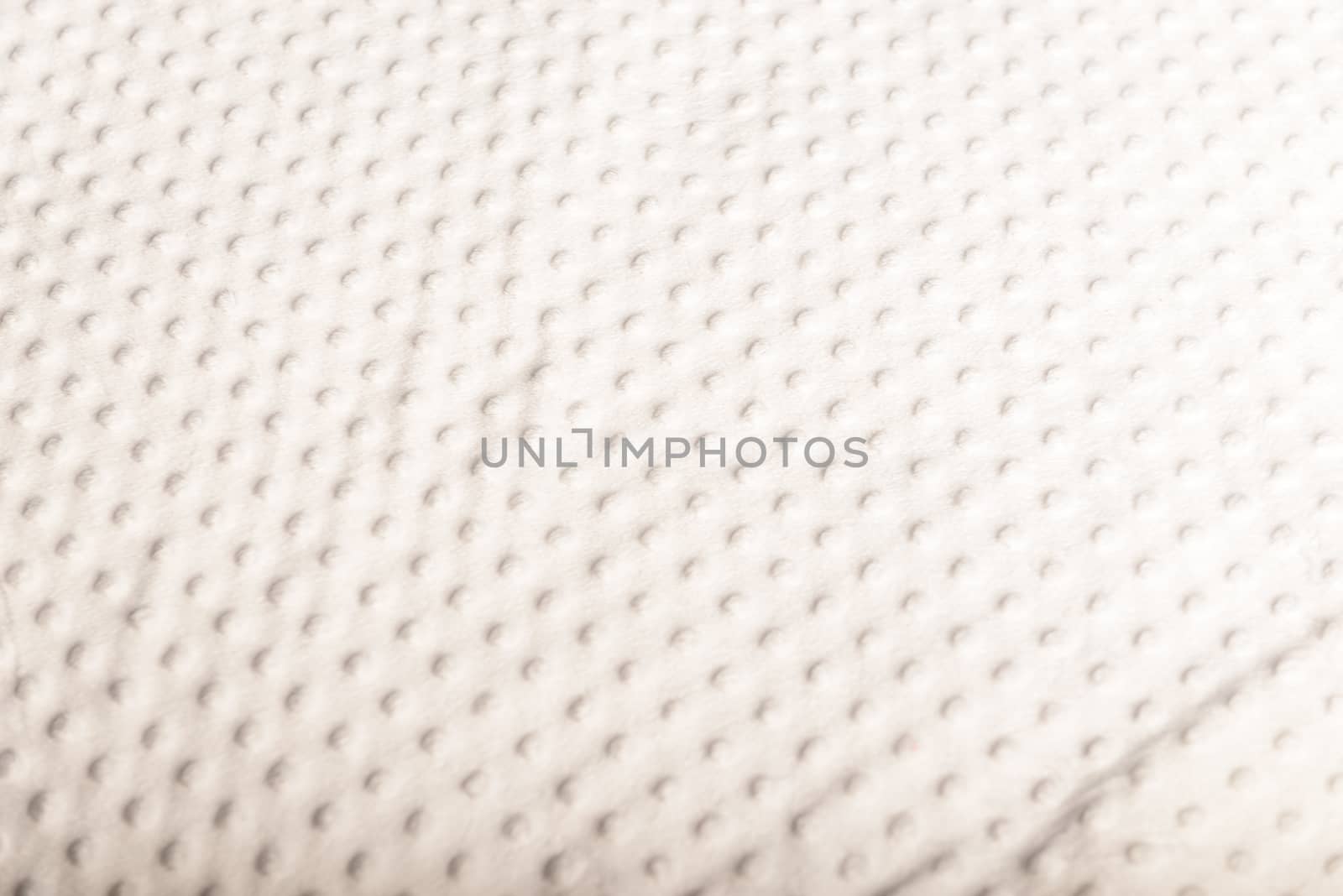 white bed cover with small green polka dot style.