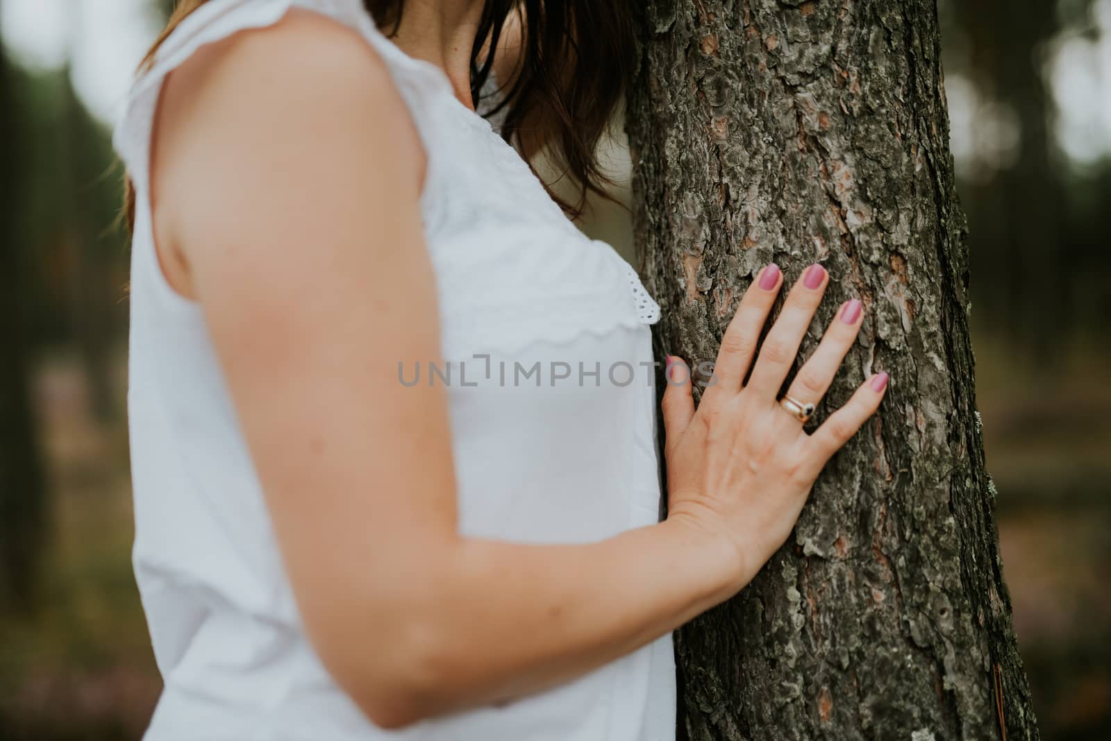 a photo of woman in the forest where the purple heather blooms. copy space