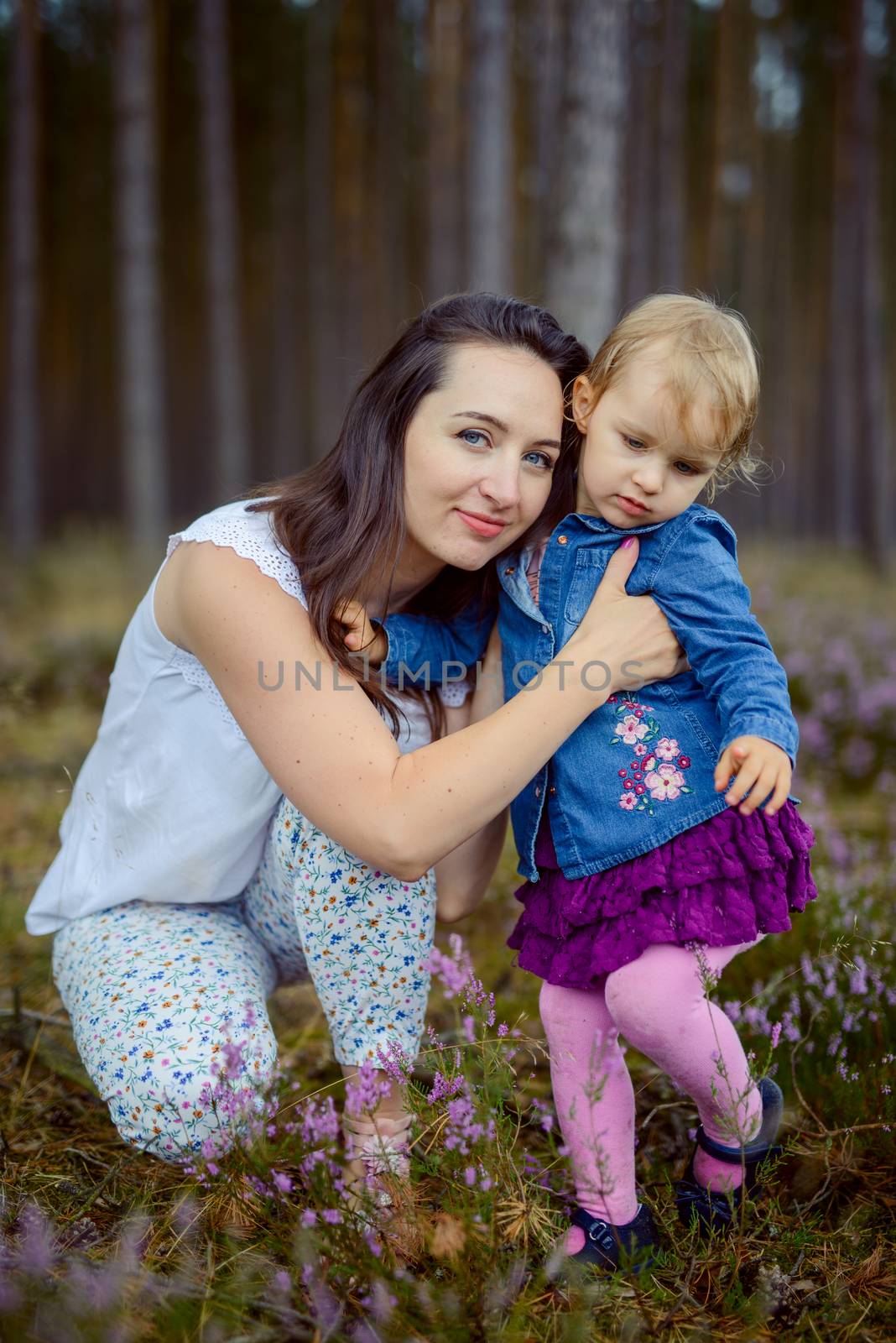 happy family mother and child little daughter running and playing on autumn walk