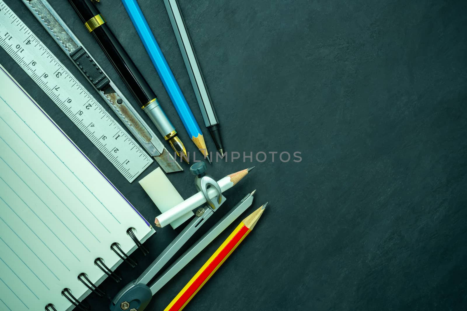 Stationery and notebook on blackboard. by SaitanSainam