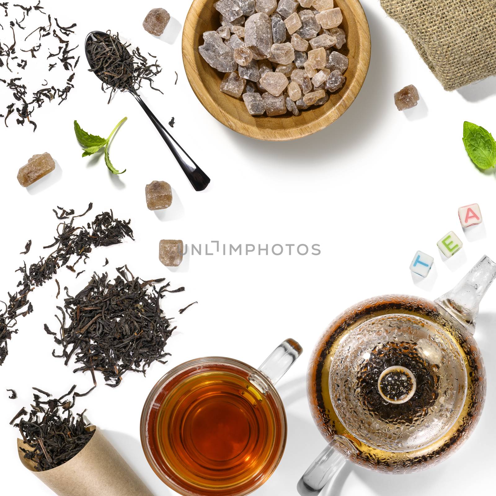 Black tea and accessories top view on white background.