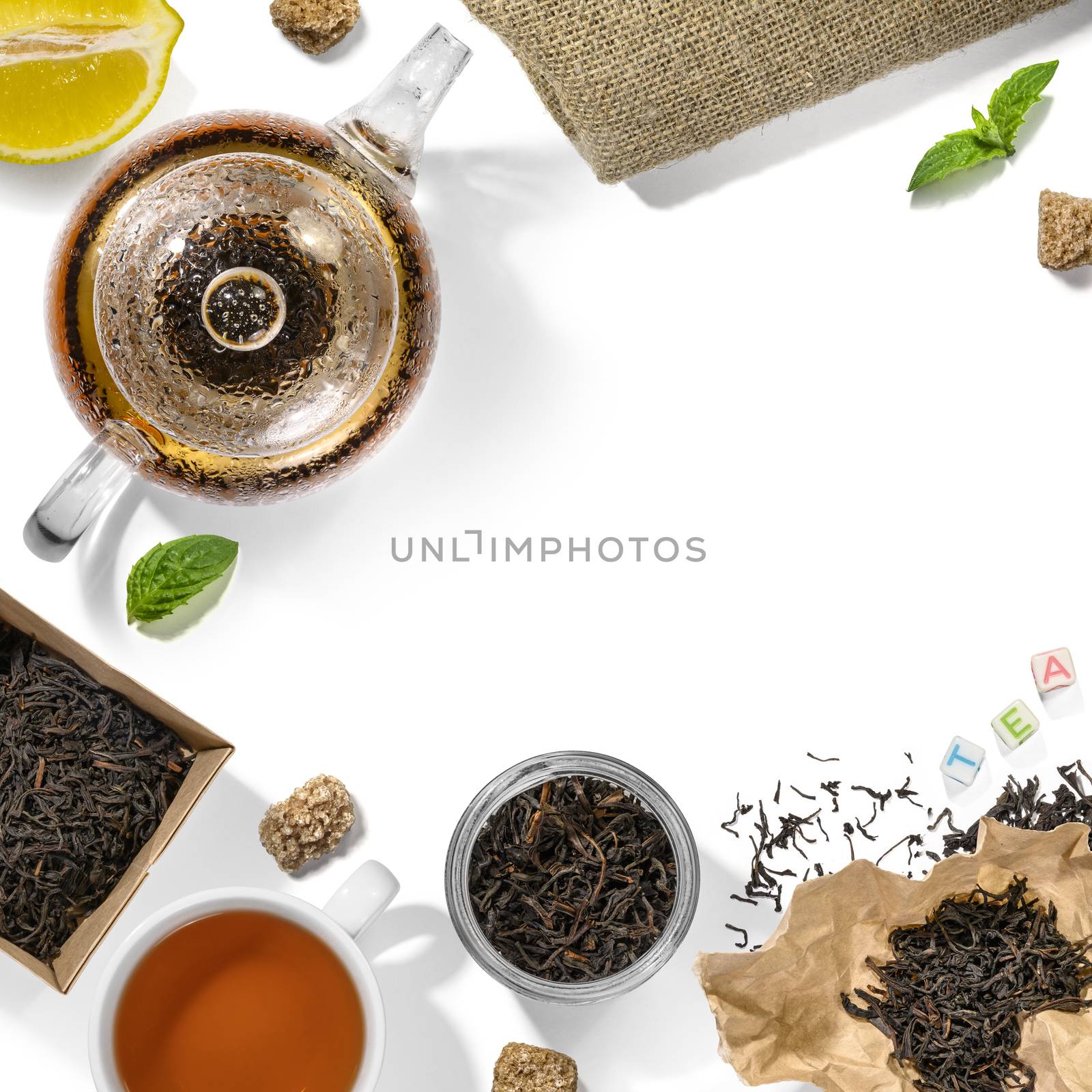 Black tea and accessories top view on white background.