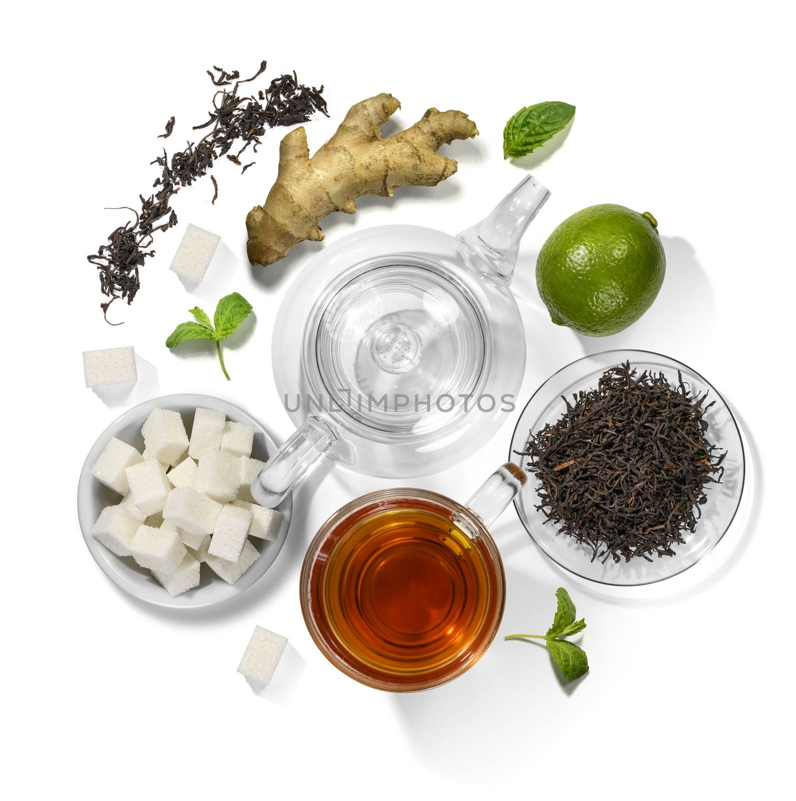 Black tea and accessories top view on white background by butenkow