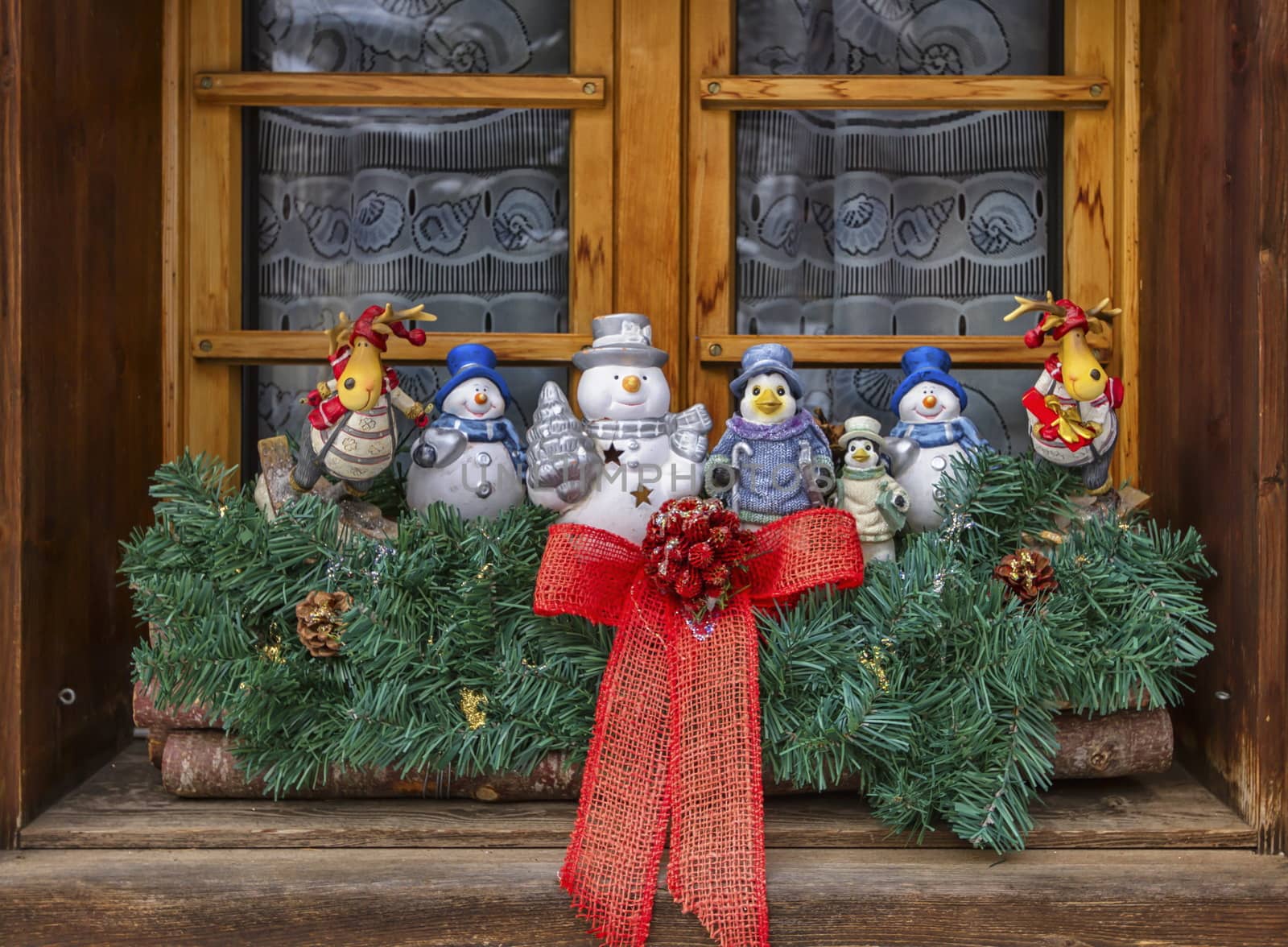 Cute Christmas decoration dolls at the window made of wood