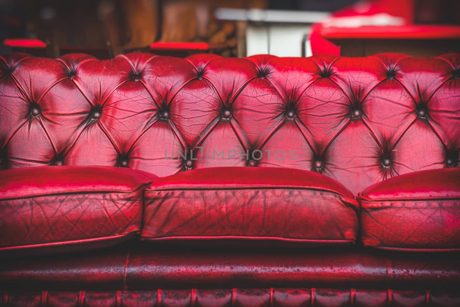 empty red sofa in cosy lounge room old-fashioned vintage closeup by LucaLorenzelli