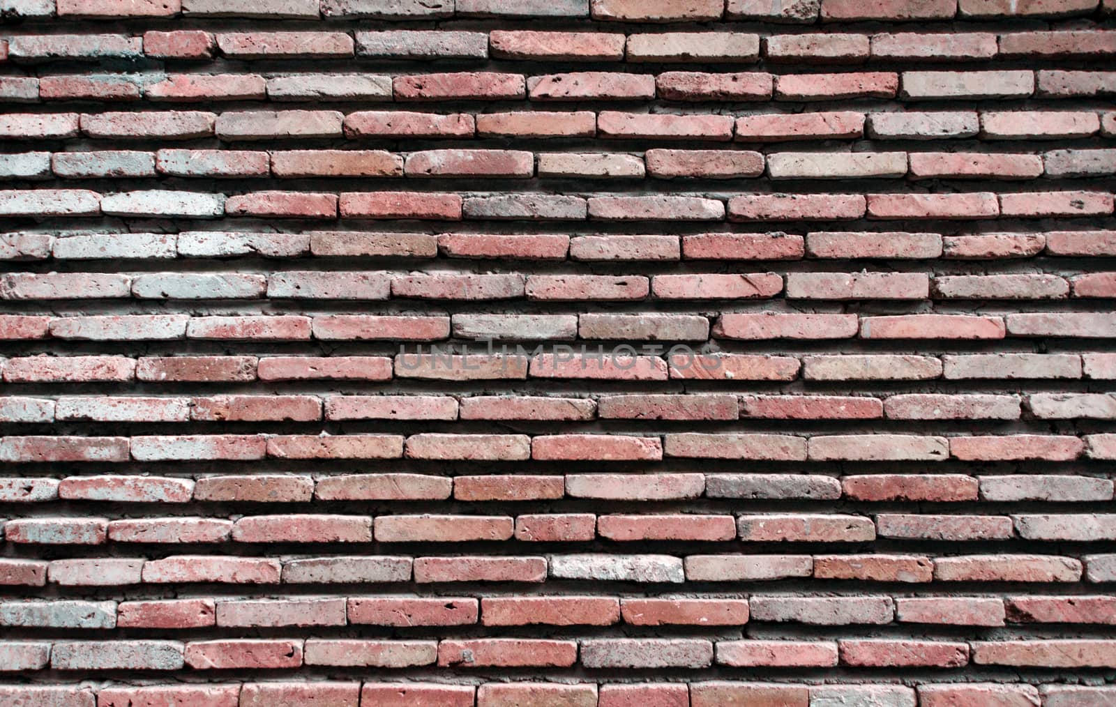 pattern background of old antique rough vintage brick stone wall close up