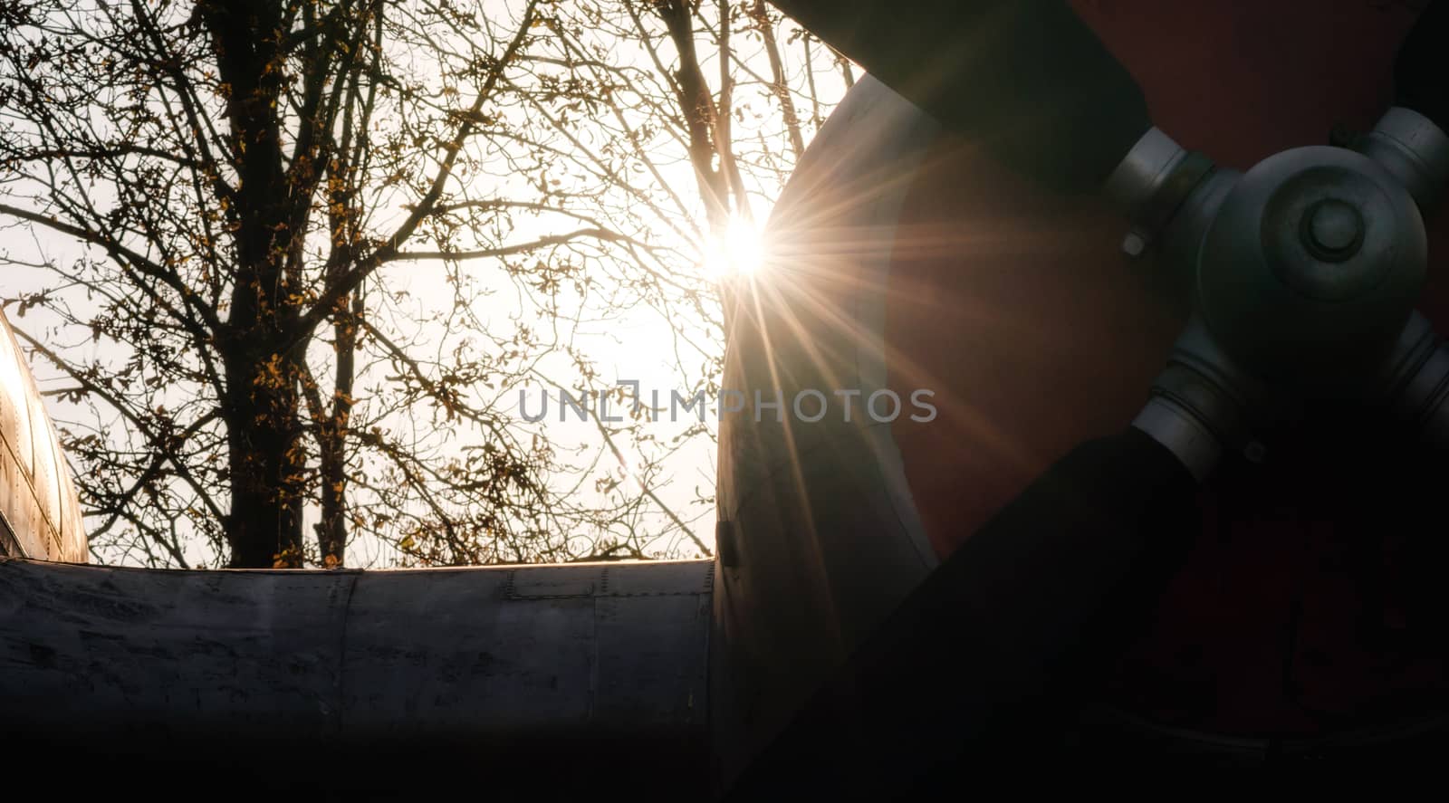 propeller of a vintage airplane in the rays of the evening sunset close up