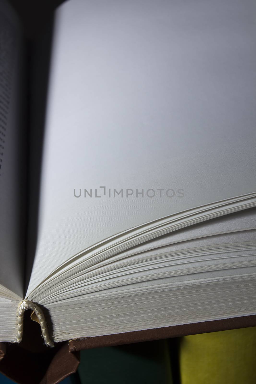 Open book on a stack of books by VIPDesignUSA