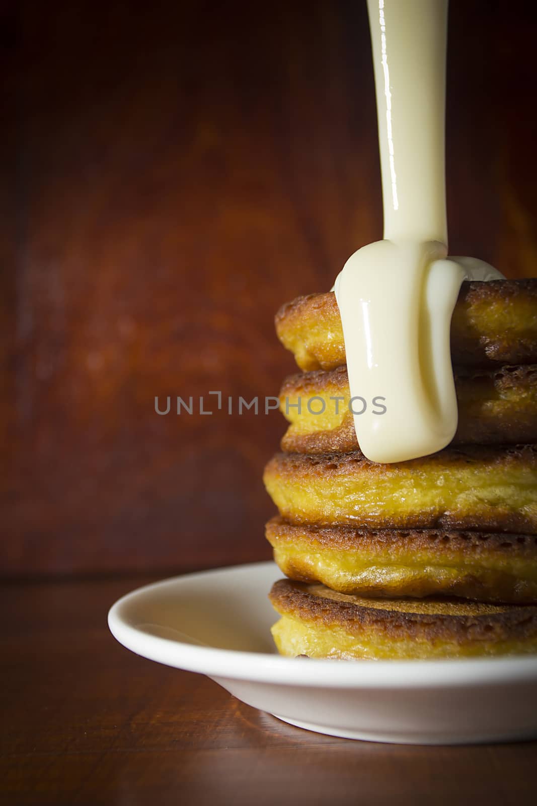 Fresh hot pancakes on a white ceramic plate