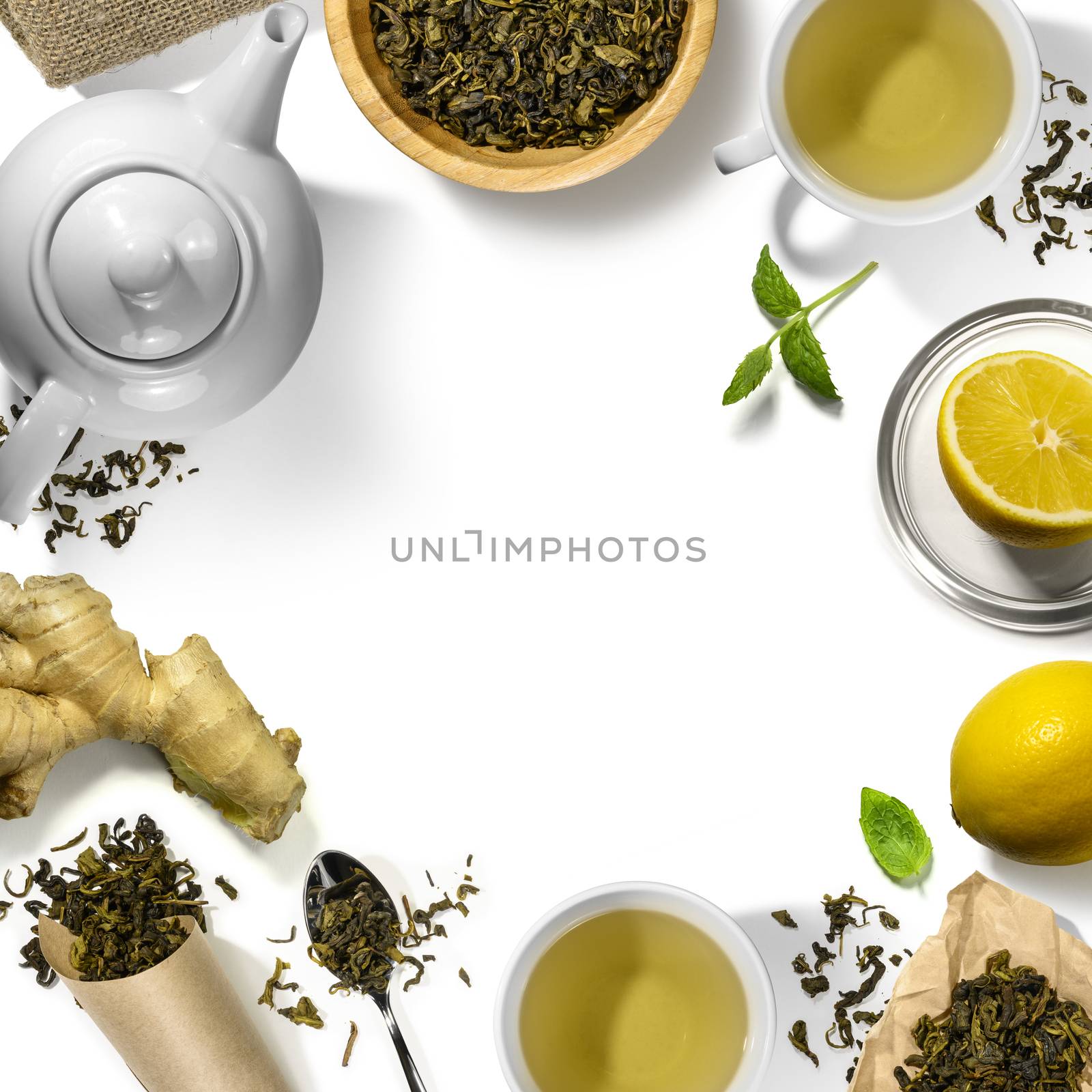 Green tea and accessories top view on white background.