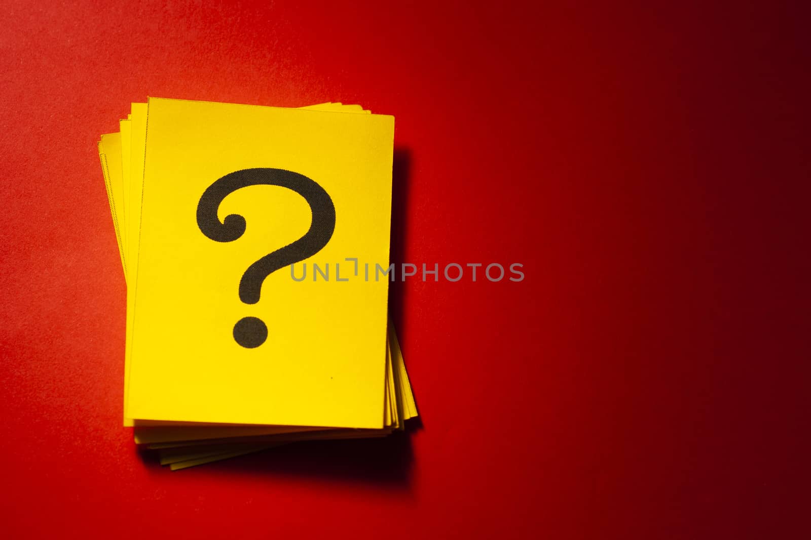 Stacked yellow cards with printed question mark by sergii_gnatiuk