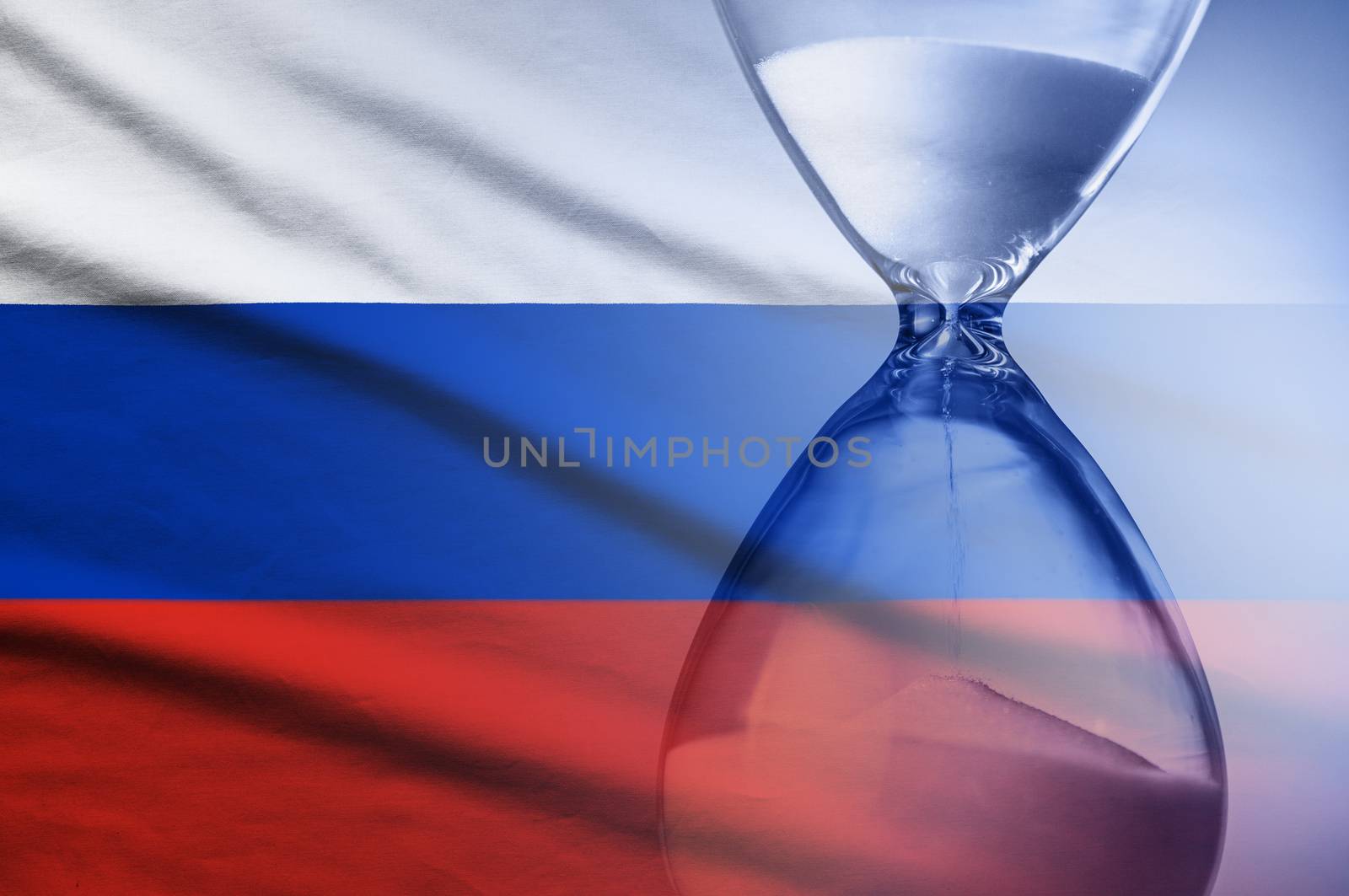 Hourglass with running sand superimposed over a Russian flag conceptual of a countdown, deadline or time management