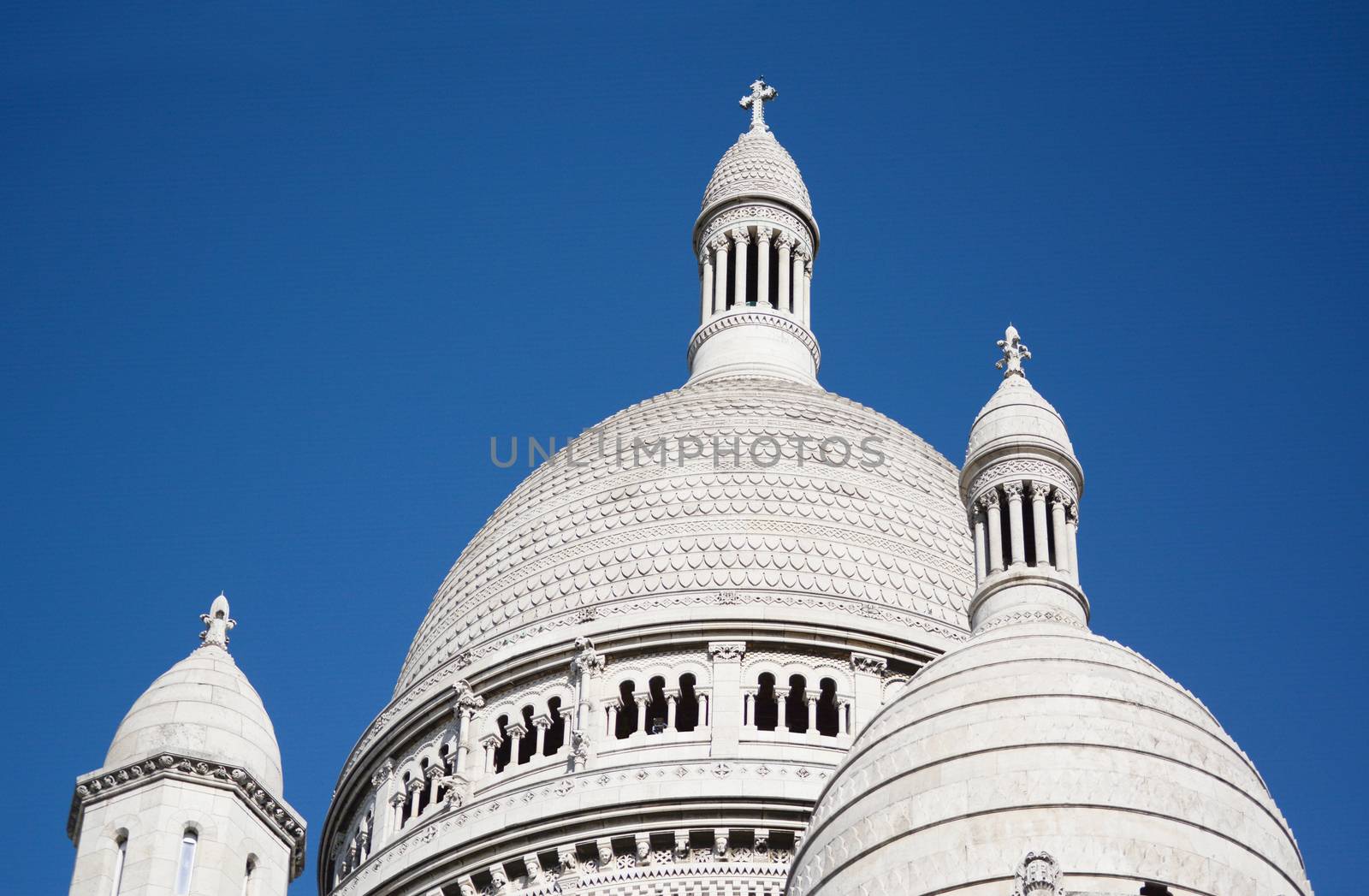 Dome rooftop of the Basilica of the Sacred Heart of Paris, ornate architecture in carved travertine limestone