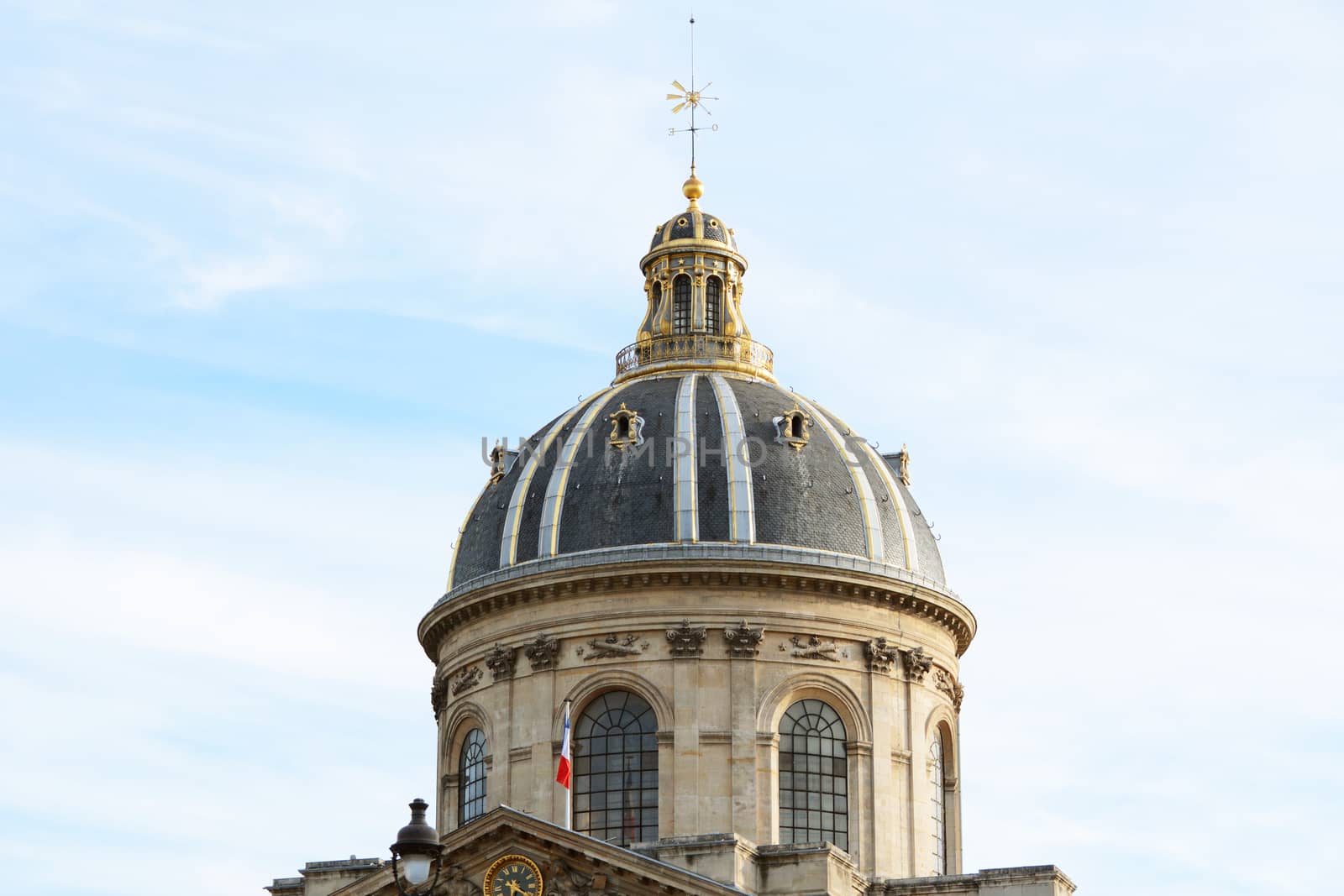 Ornate gilded dome and weather vane of the French Institute in Paris - Institut de France