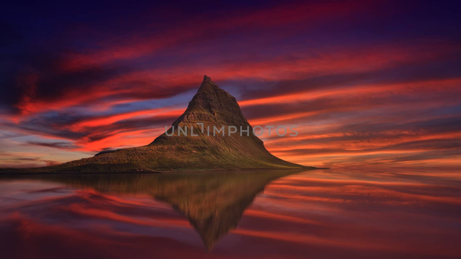 In images Aerial view of Kirkjufell mountain with beautiful aurora borealis in winter, Iceland. One of the famous natural heritage in Iceland.