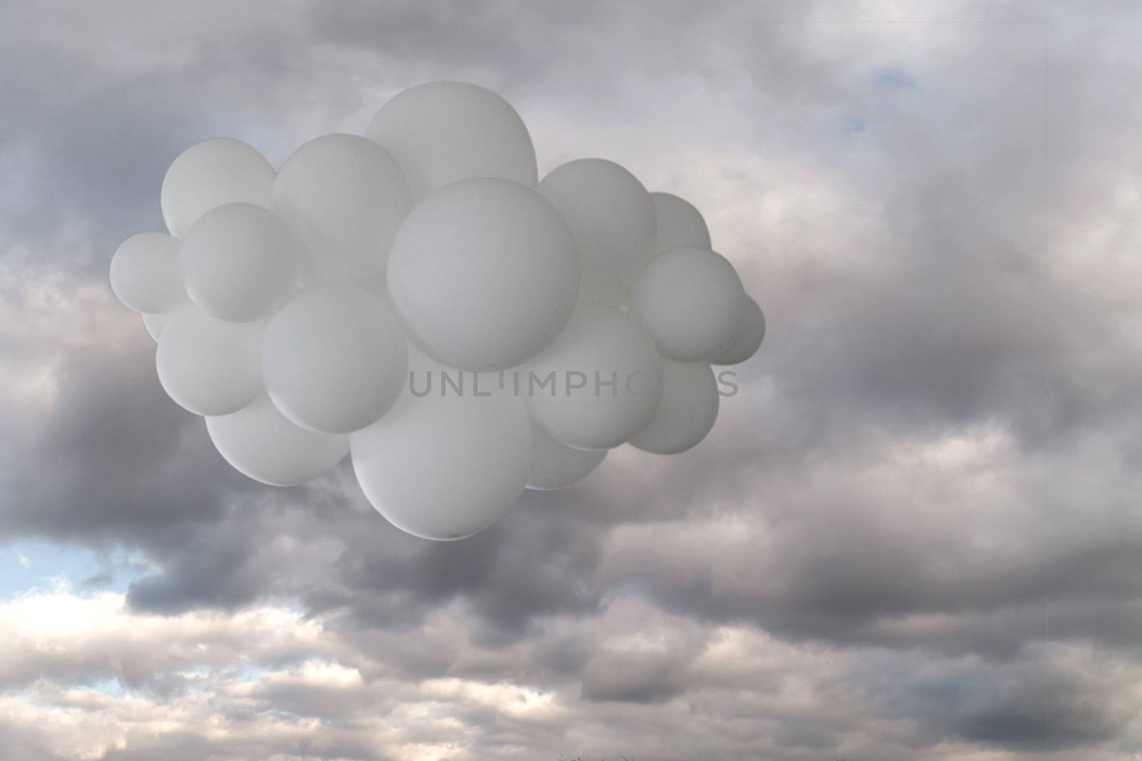White cloud of helium balloons against a cloudy sky.