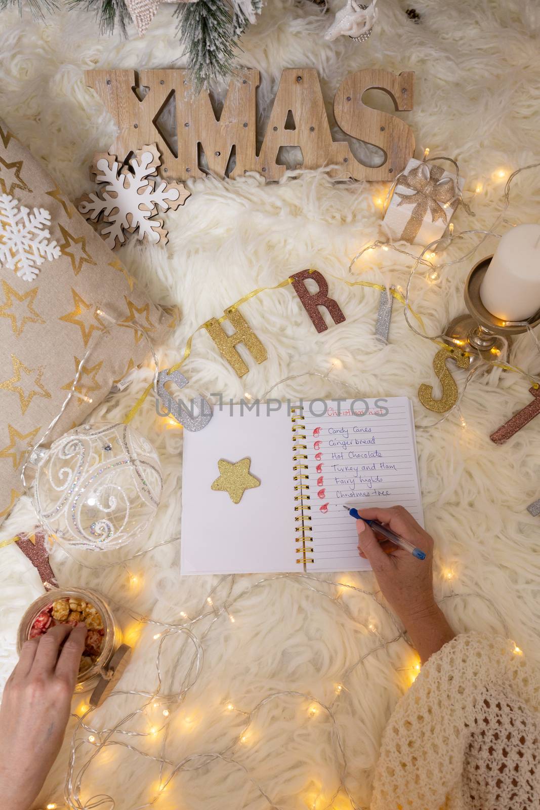 A woman writes out a Christmas shopping list