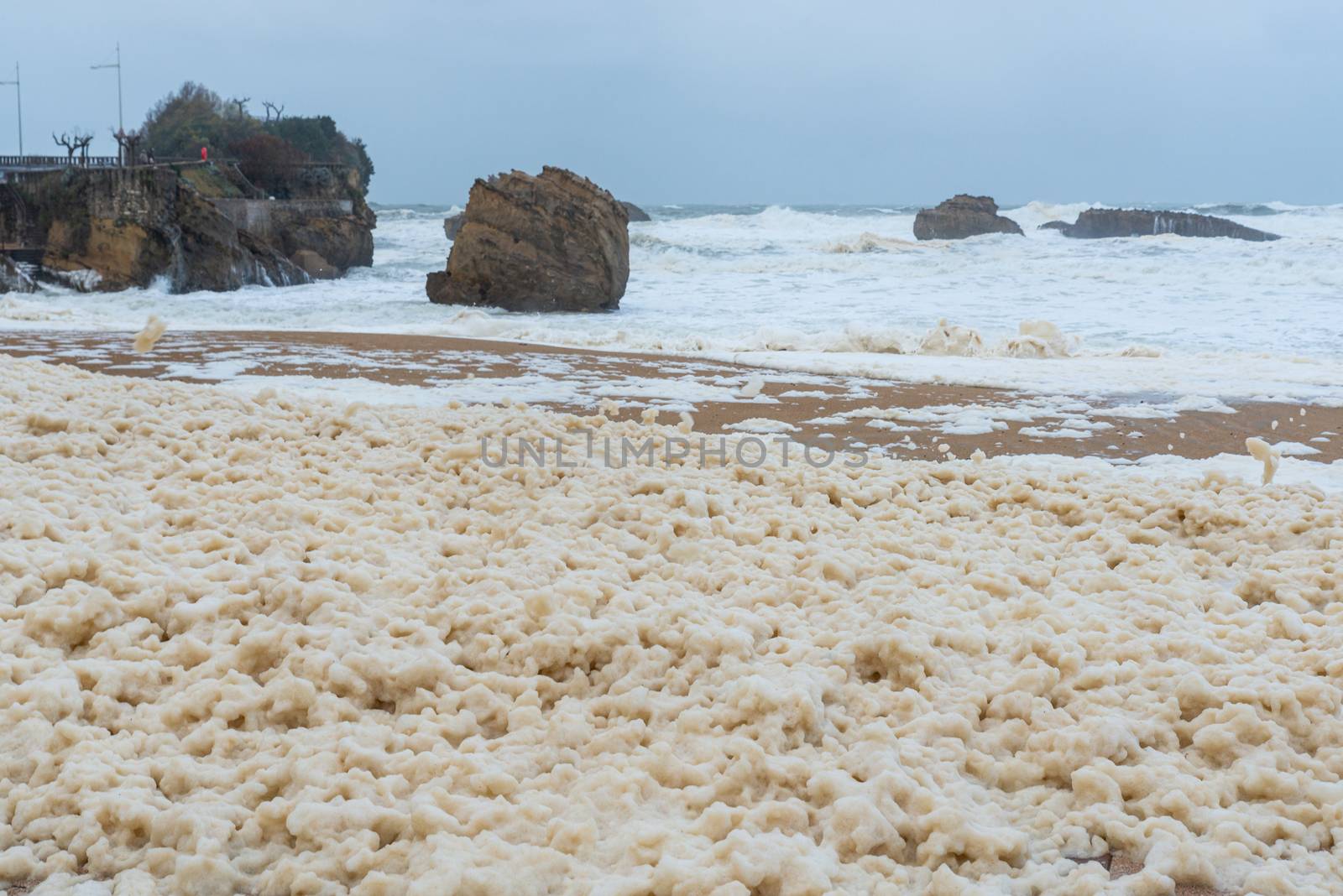 Foam on the Grande Plage beach and its quay, France by dutourdumonde