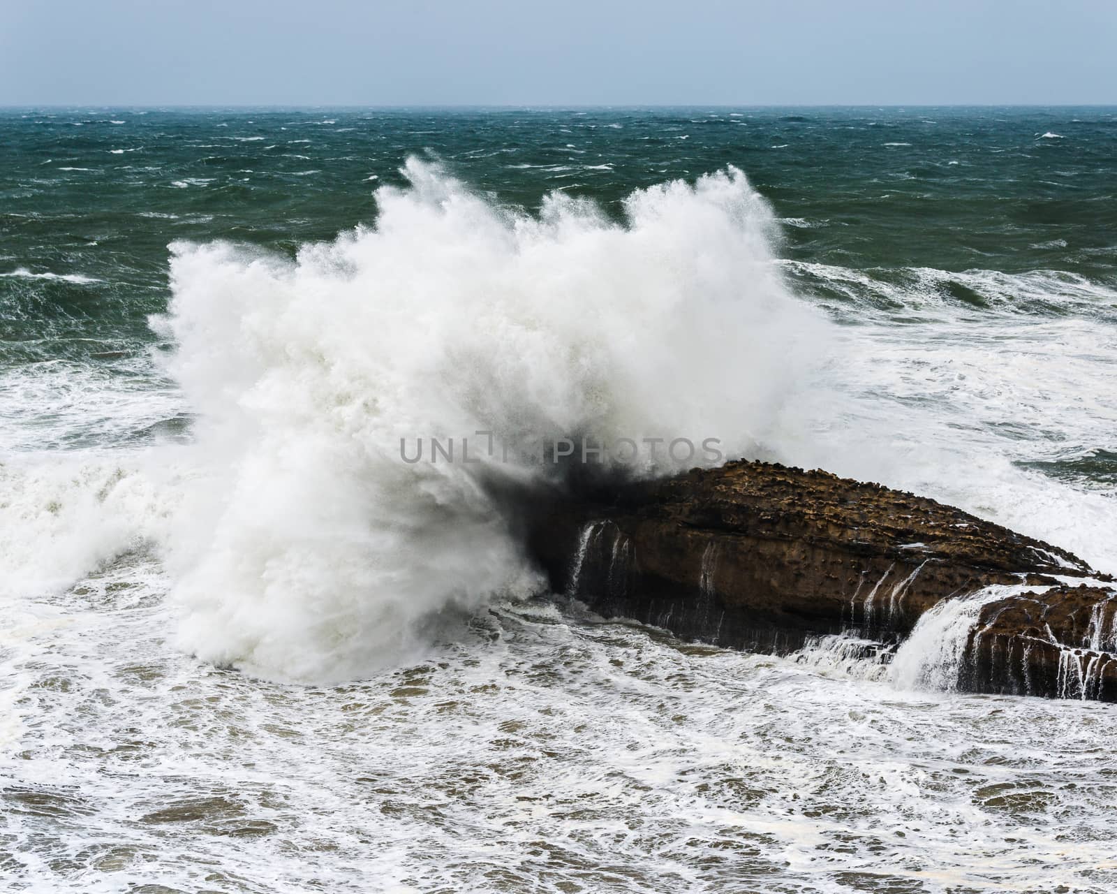 Wave crashing on rock by a stormy day on the Atlantic coast in southwest France