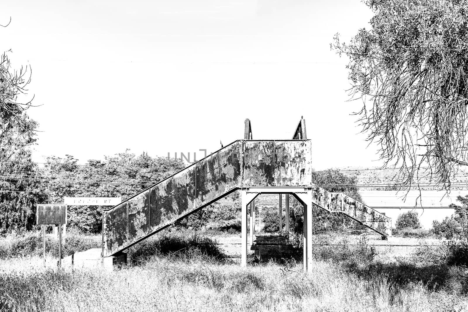 Rusted, old pedestrian railway bridge, in Brandfort. Monochrome by dpreezg