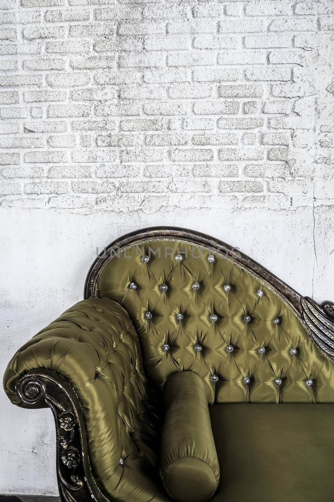 antique sofa on brick wall background by ponsulak