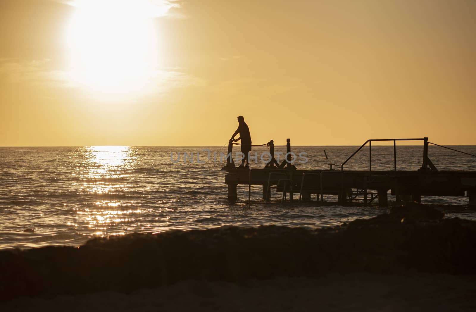 Fisherman on the pier at sunset in Bayahibe 8 by pippocarlot