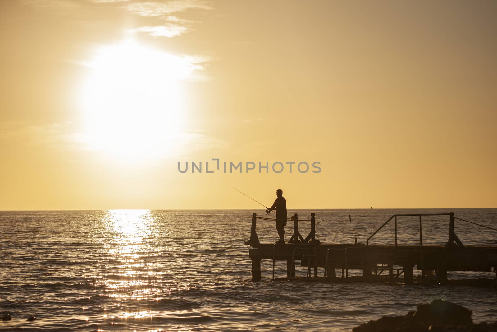 Fisherman on the pier at sunset in Bayahibe in the Dominican Republic