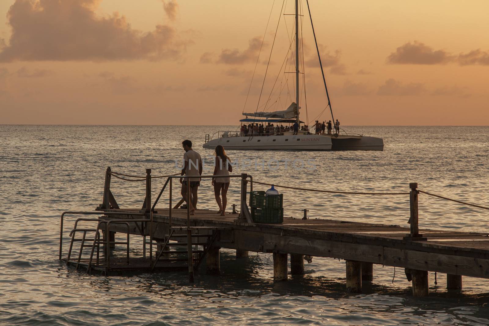 People on the pier at sunset by pippocarlot