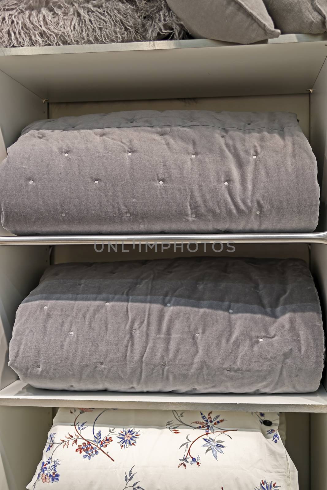 Folded thick blankets designed for the cold season. Grey, natural material.