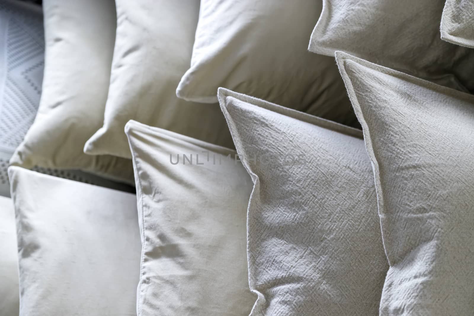 Lots of soft down white pillows convenient for a pleasant sleep.