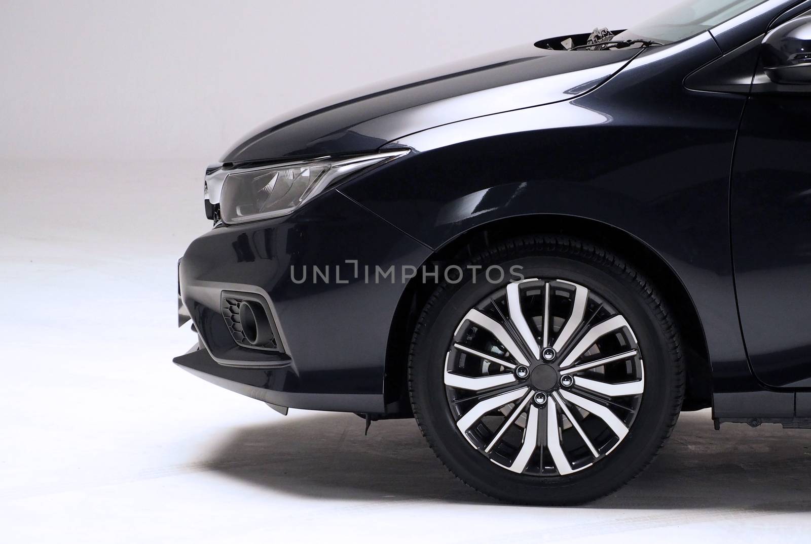 Parts of automotive car black color such as window, wheel, lamp, mirror, side shots shooting from front and rear on white background in studio production and for use in automobile industry.