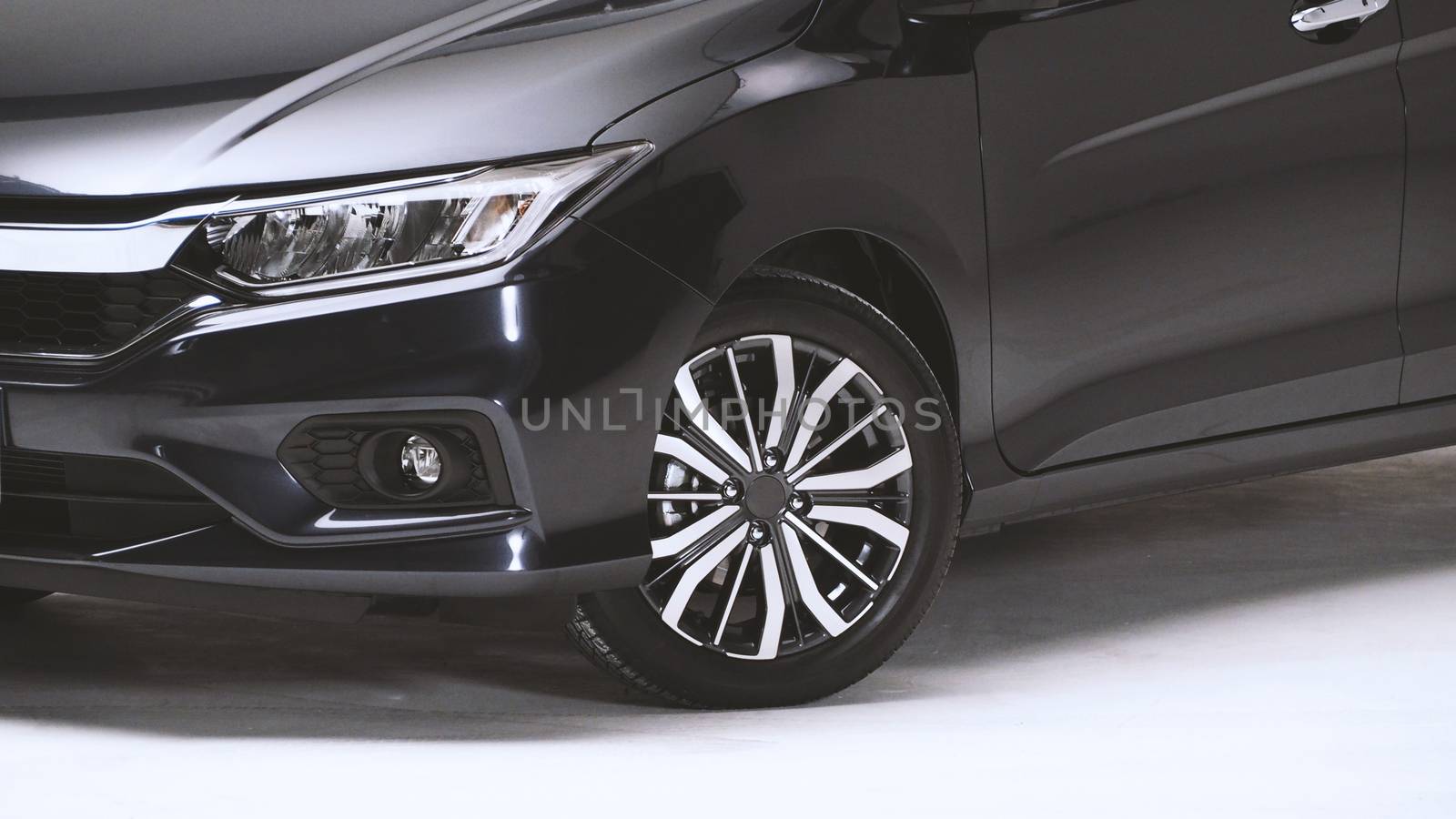 Parts of automotive car black color such as window, wheel, lamp, mirror, side shots shooting from front and rear on white background in studio production and for use in automobile industry.