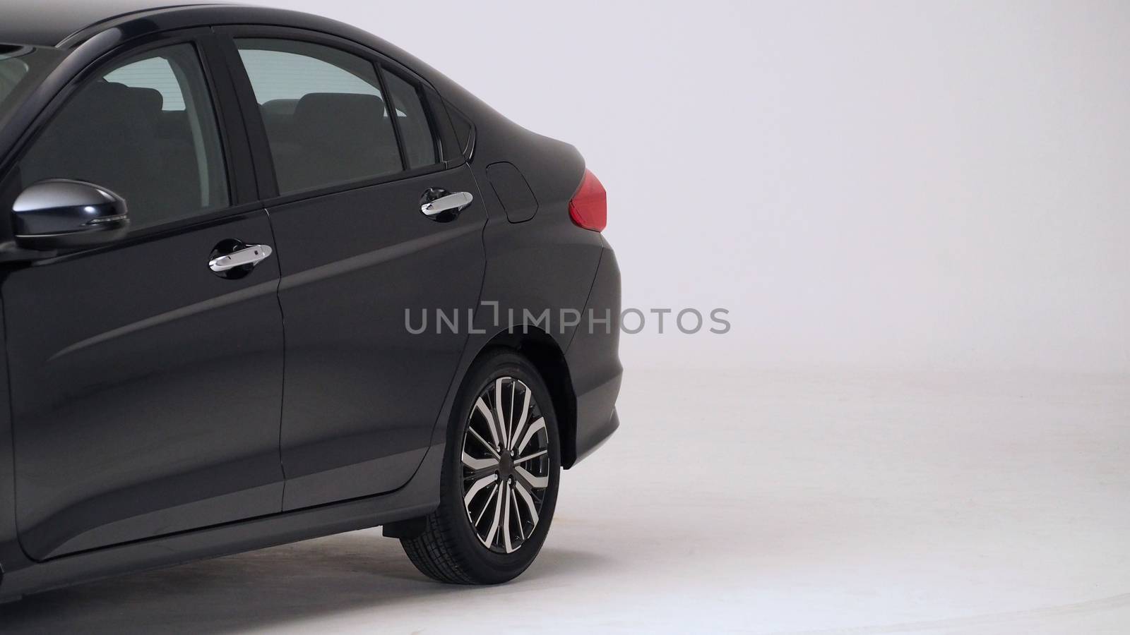 Parts of automotive car black color such as window, wheel, lamp, mirror, side shots shooting from front and rear on white background in studio production and for use in automobile industry.