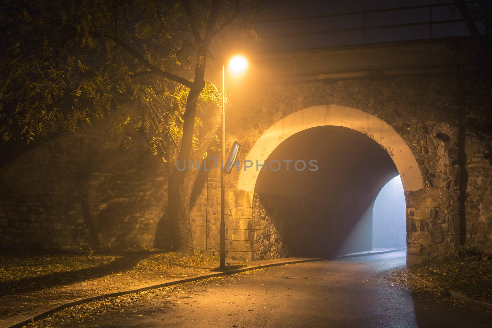 The Tunnel. Way out with spooky mist and fog at night. Single lamp and light from the other side. Afterlife concept. by petrsvoboda91
